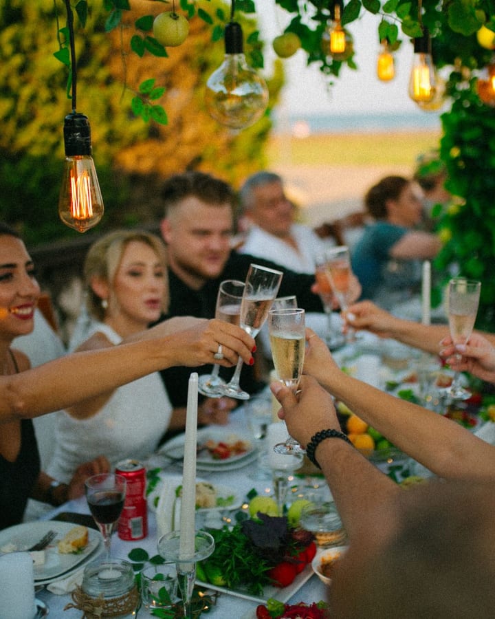Guests raising a champagne toast at an outdoor celebration