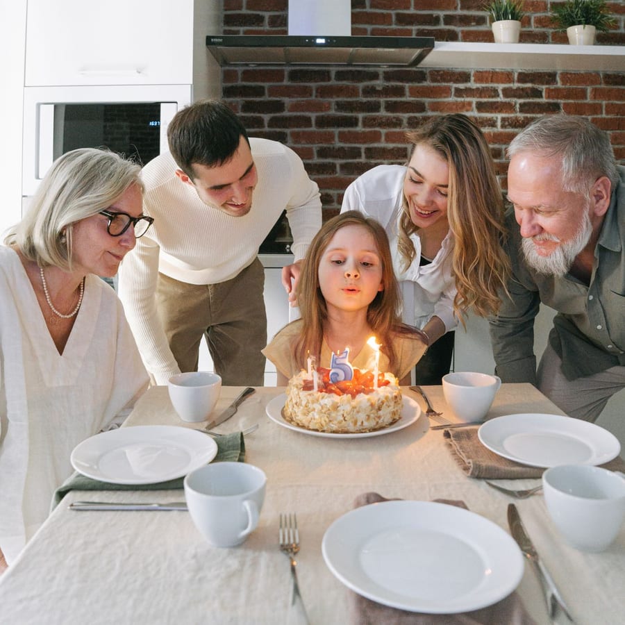 A girl blowing out the candles on her birthday cake