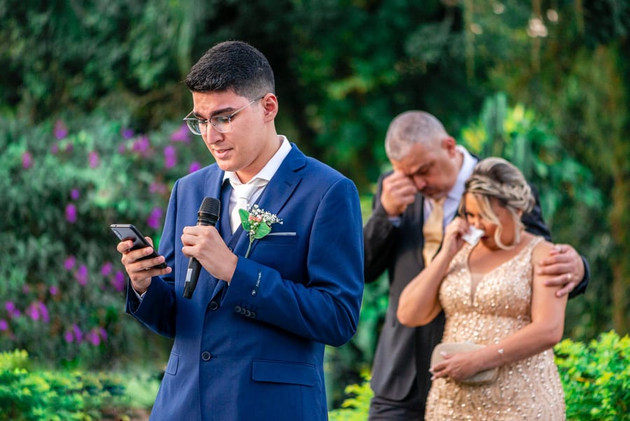 A guest giving a speech at an outdoor wedding